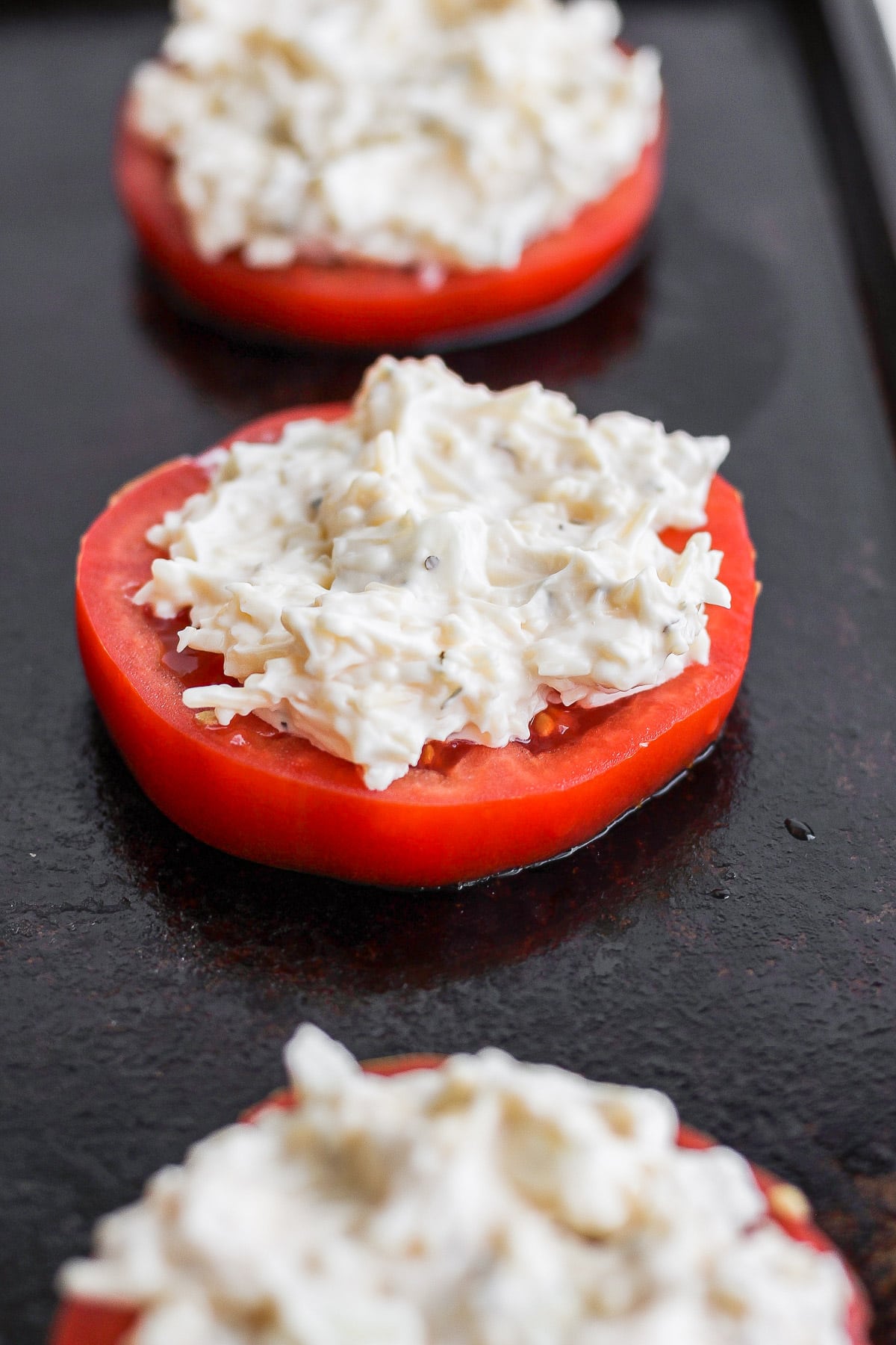 Sliced tomatoes with a mayo parmesan mixture on top. 