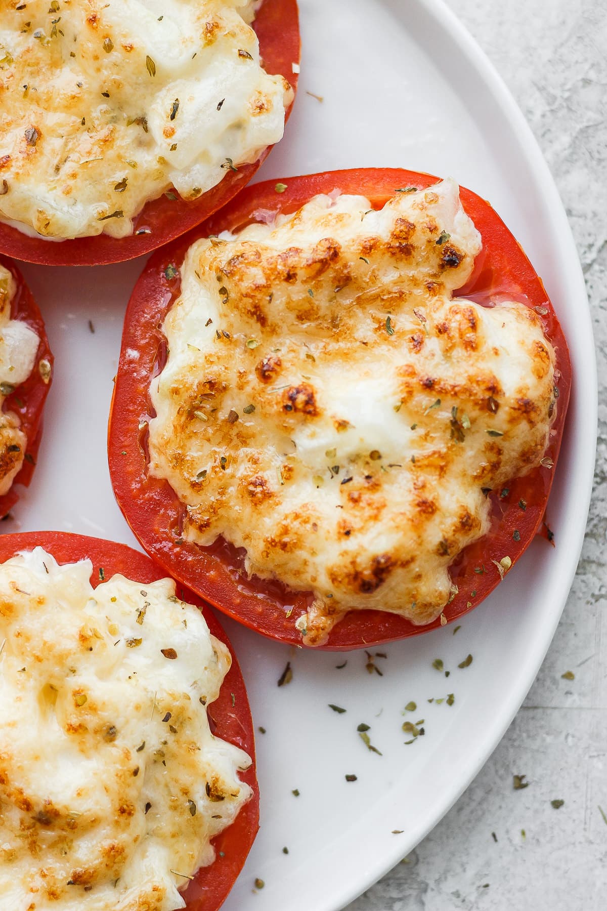 Plate of broiled tomatoes. 