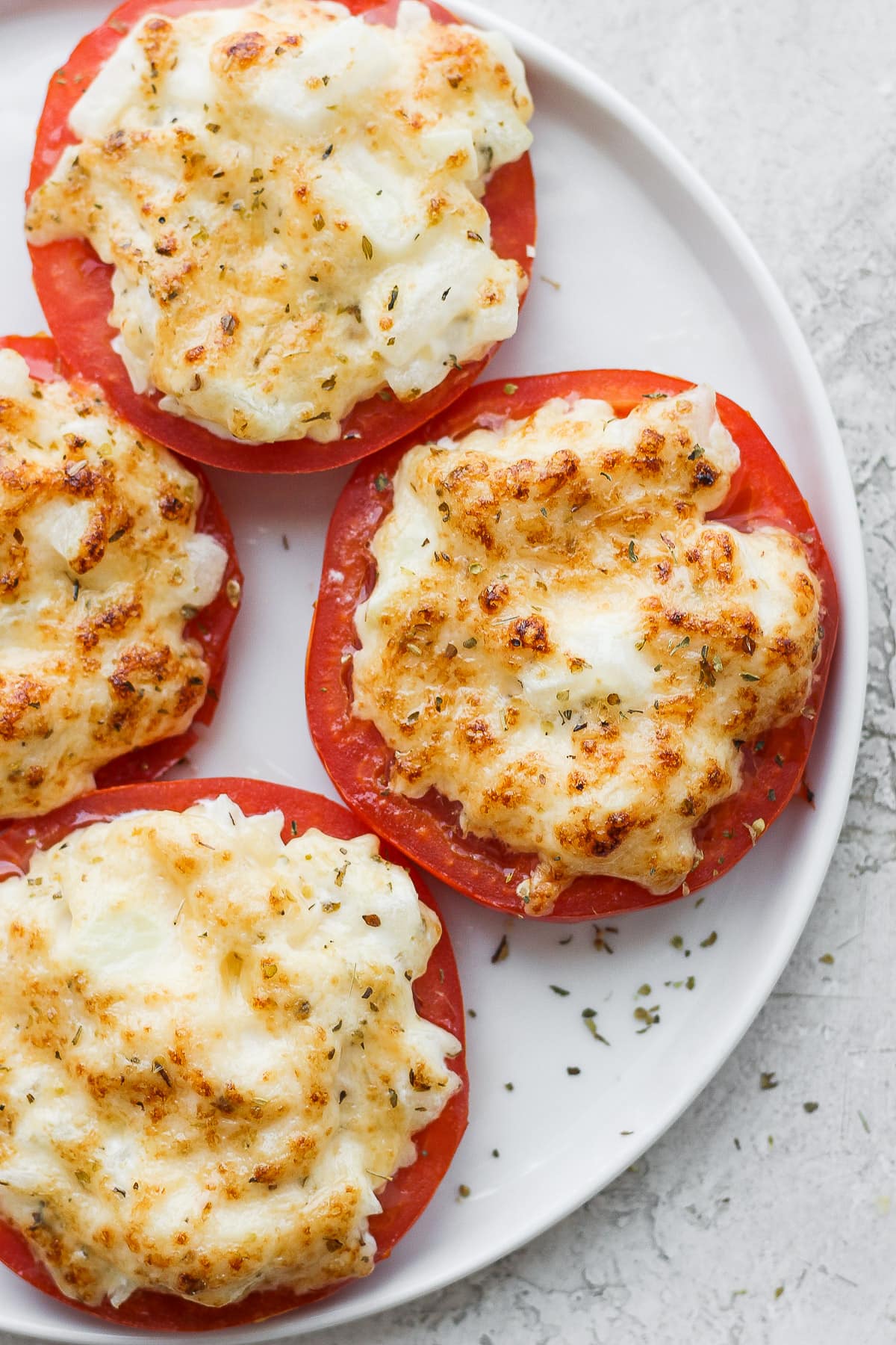 Plate of broiled tomatoes. 