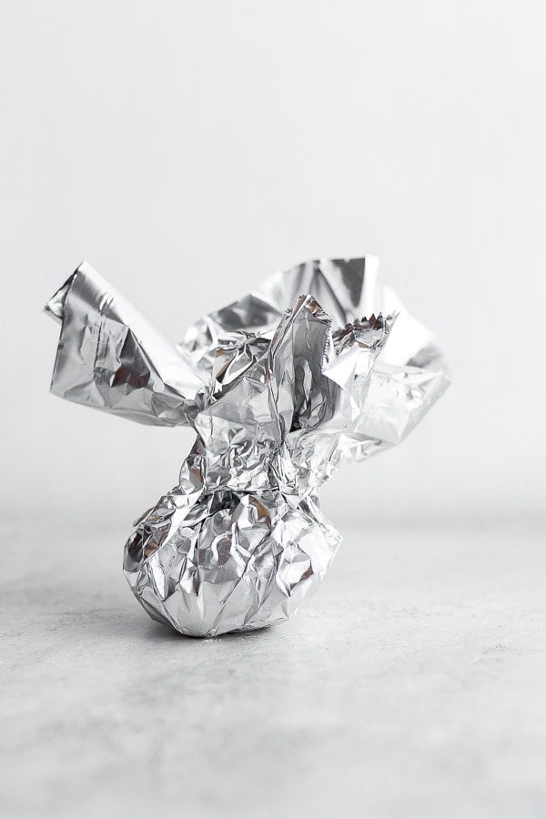 Showing how you can wrap up garlic with foil. 