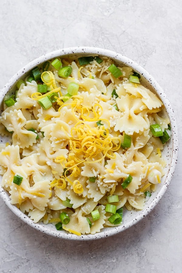 Bowl of lemon pasta with lemon zest on top.