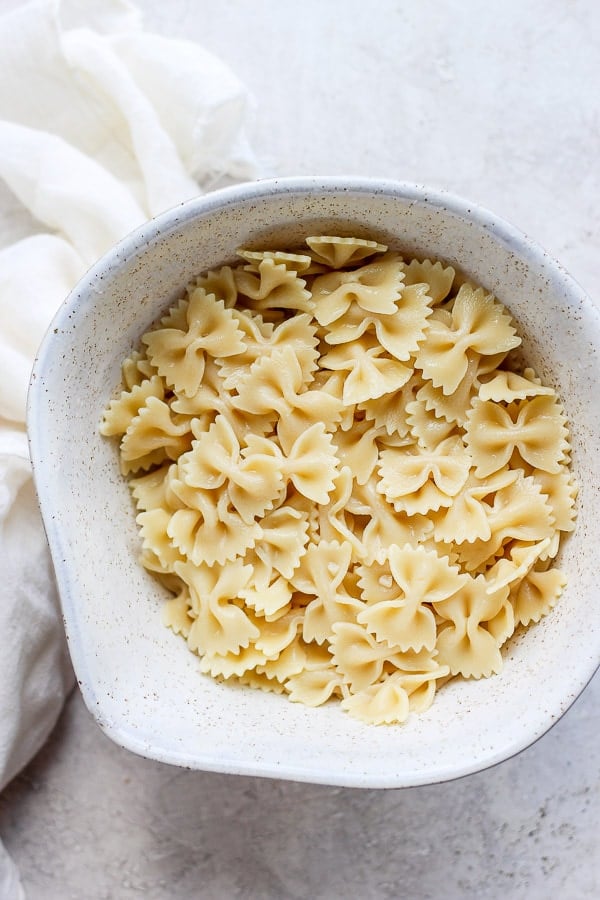 Cooked farfalle pasta in a mixing bowl.