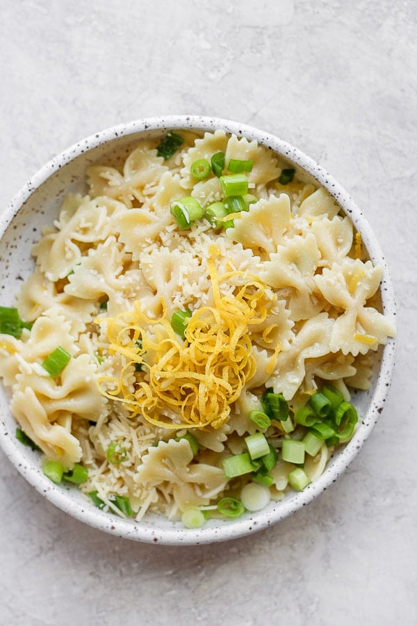 Bowl of lemon pasta with lemon zest on top.