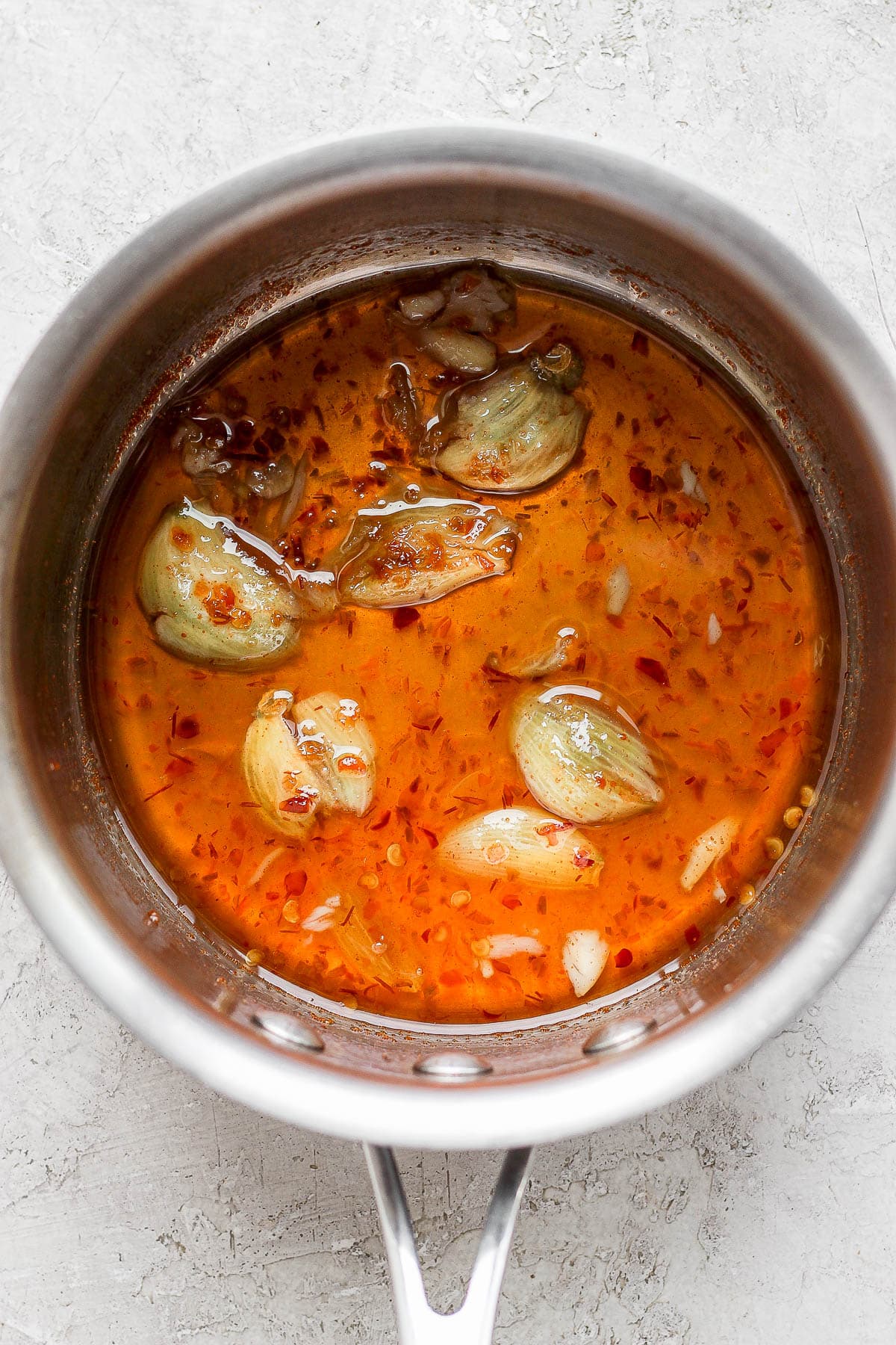 Small sauce pan with spring roll dipping sauce ingredients being simmered. 