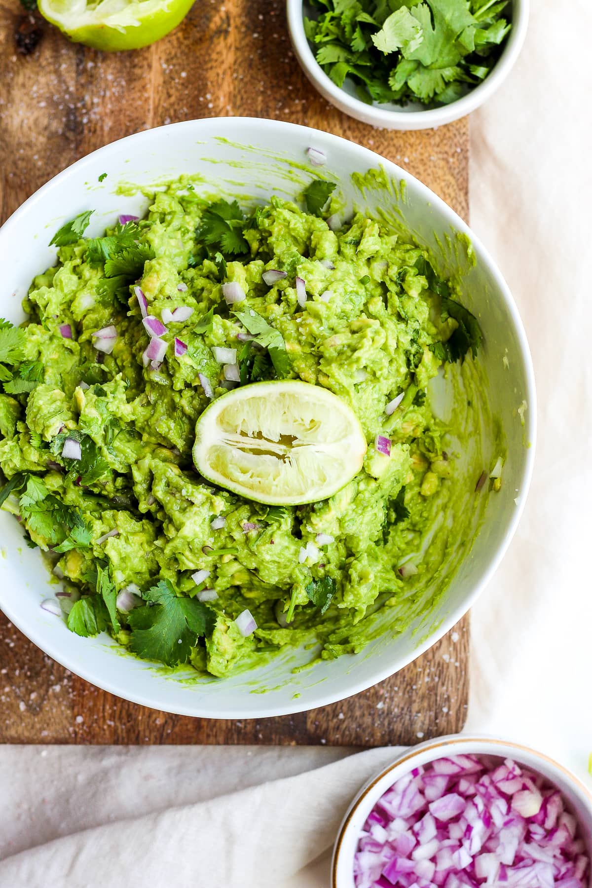 Homemade guacamole in a white bowl.