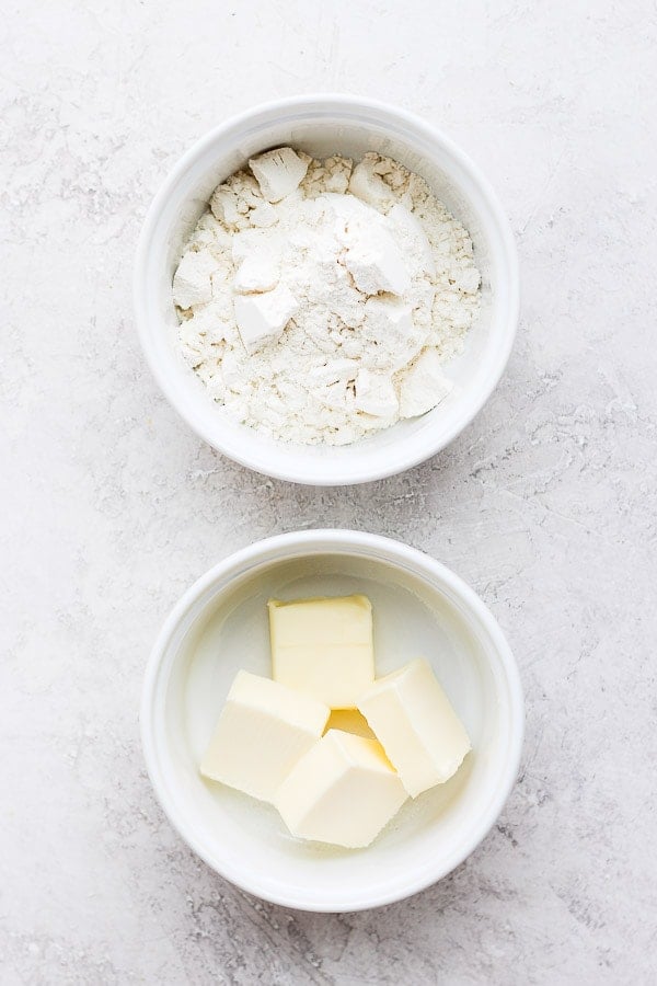 A dish of a few tablespoons of flour and a dish with 4 tablespoons of butter.