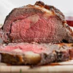 Prime rib on a wooden cutting board.