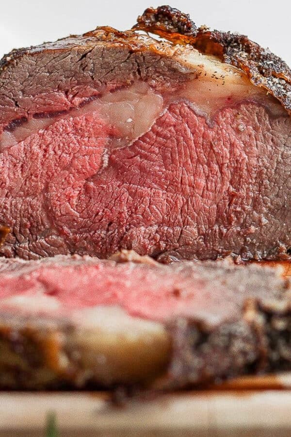 Prime rib on a wooden cutting board.