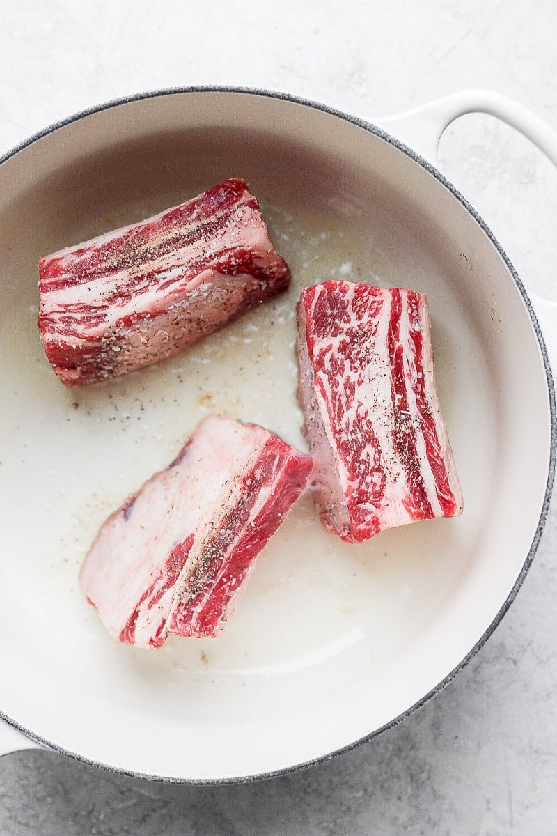 Short ribs being seared in a Dutch Oven.