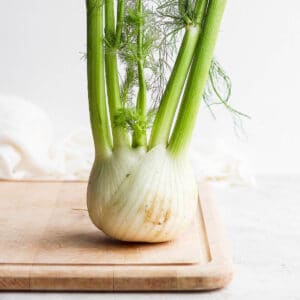 A fennel bulb on a wooden cutting board.