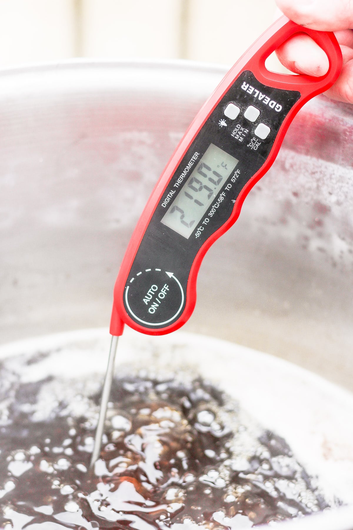 Maple syrup with a digital thermometer showing it is 219 degrees. 