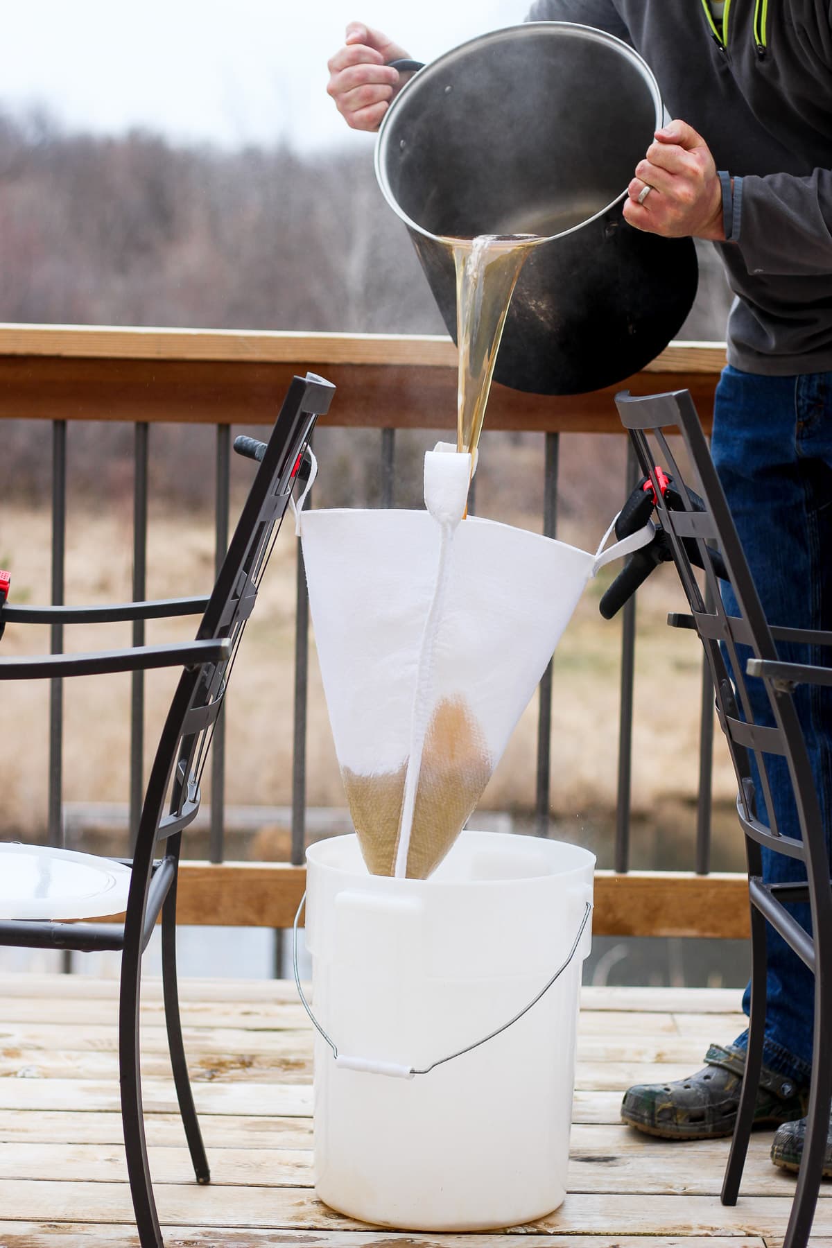 Maple syrup being poured through a filter. 