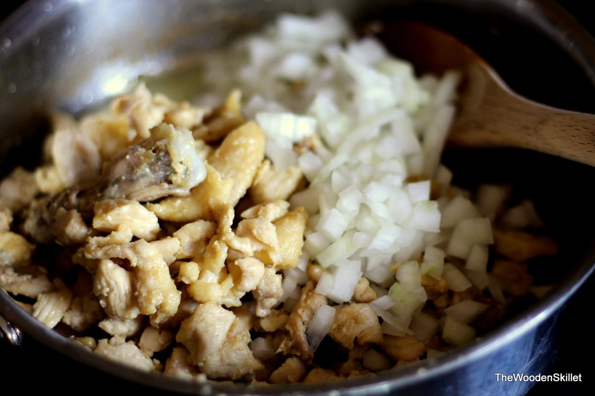 Adding in onions to the pan with the schmaltz. 