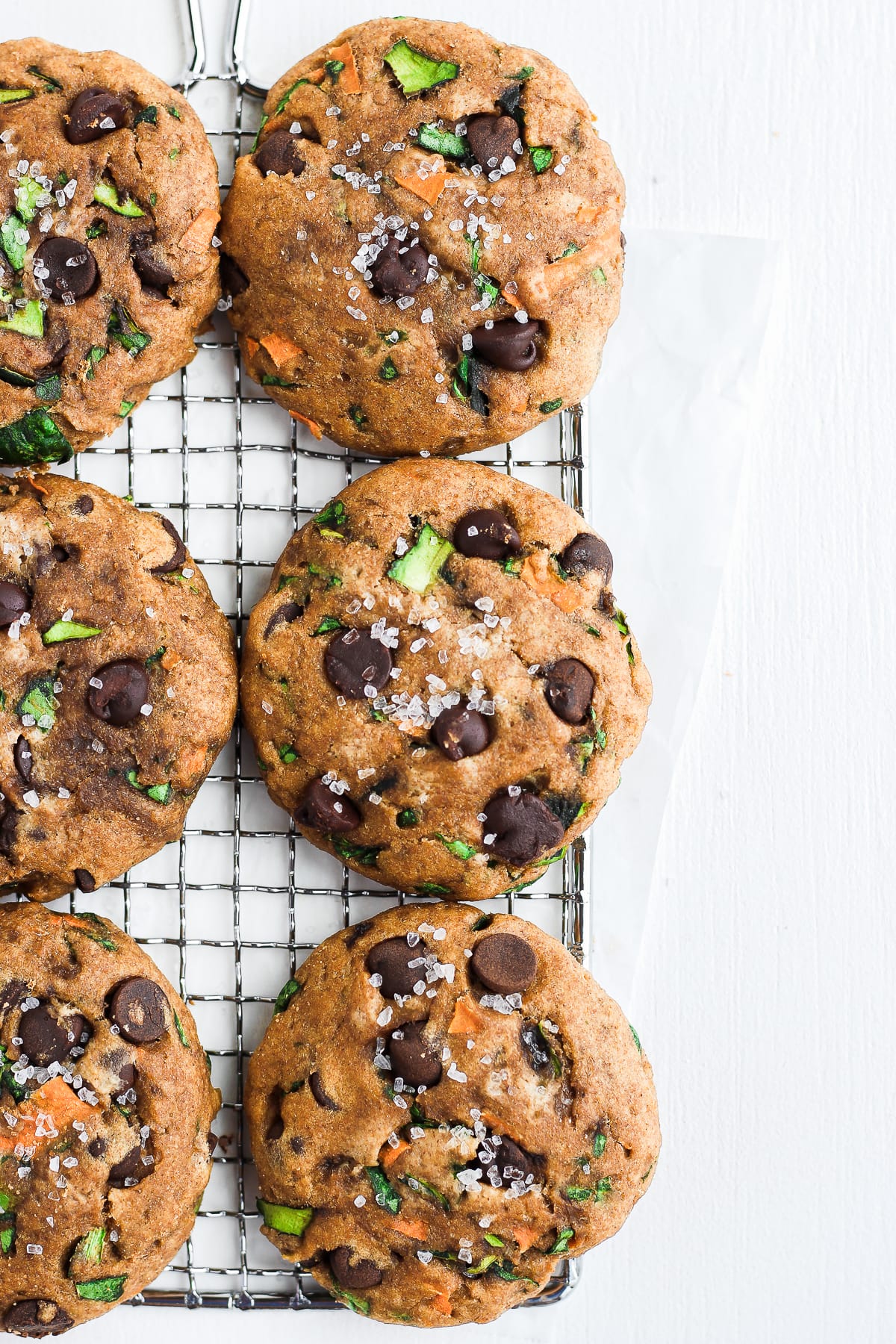 Healthy Chocolate Chip Cookies lined up on a cooling rack. 