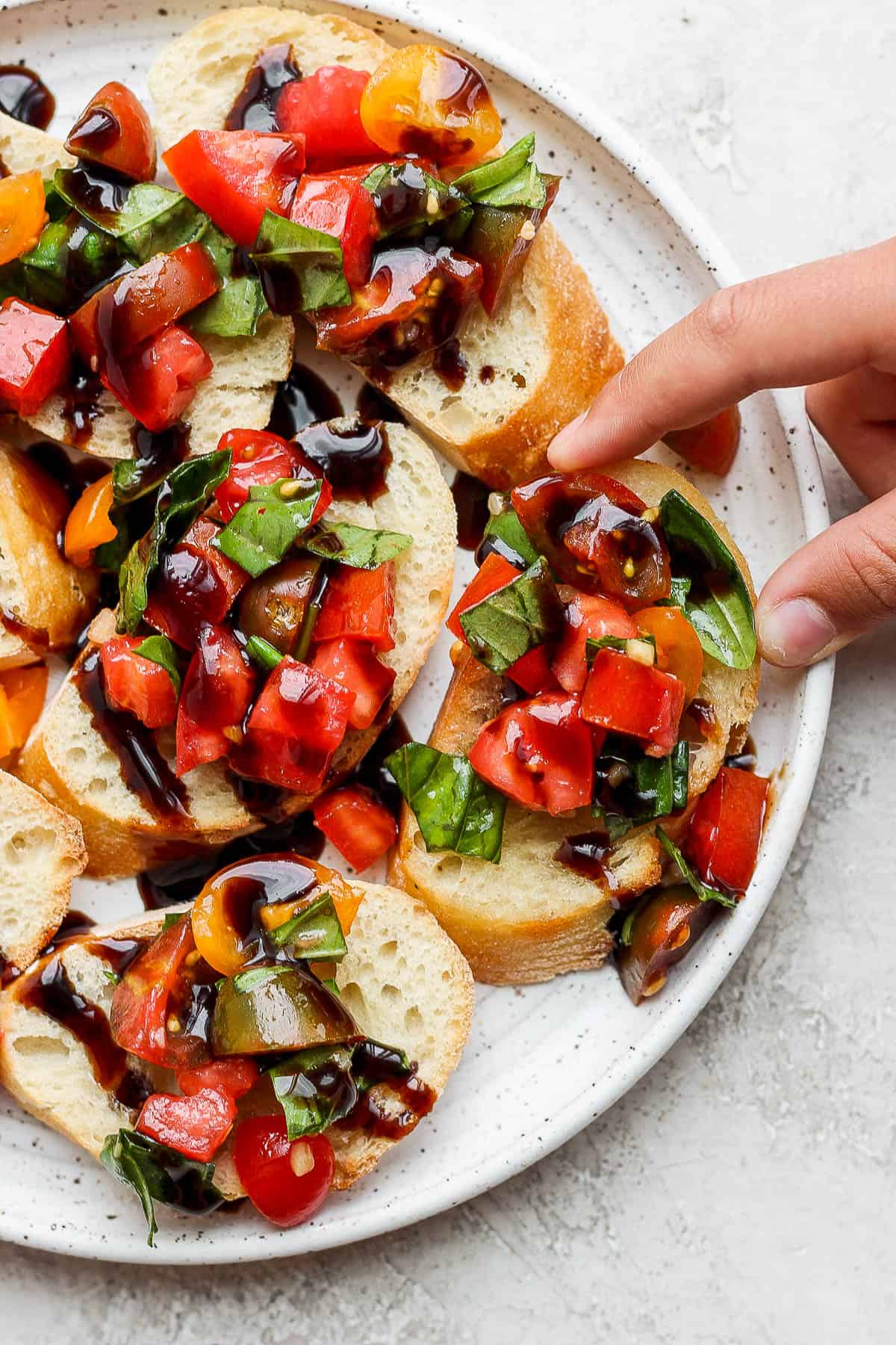 Fresh bruschetta on baguettes on a plate.