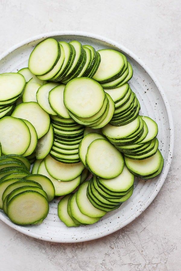 Thinly sliced zucchini on a plate.