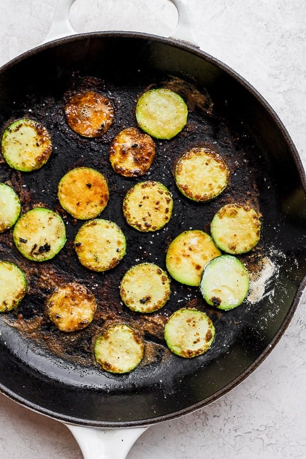 Fried zucchini in a cast iron skillet.