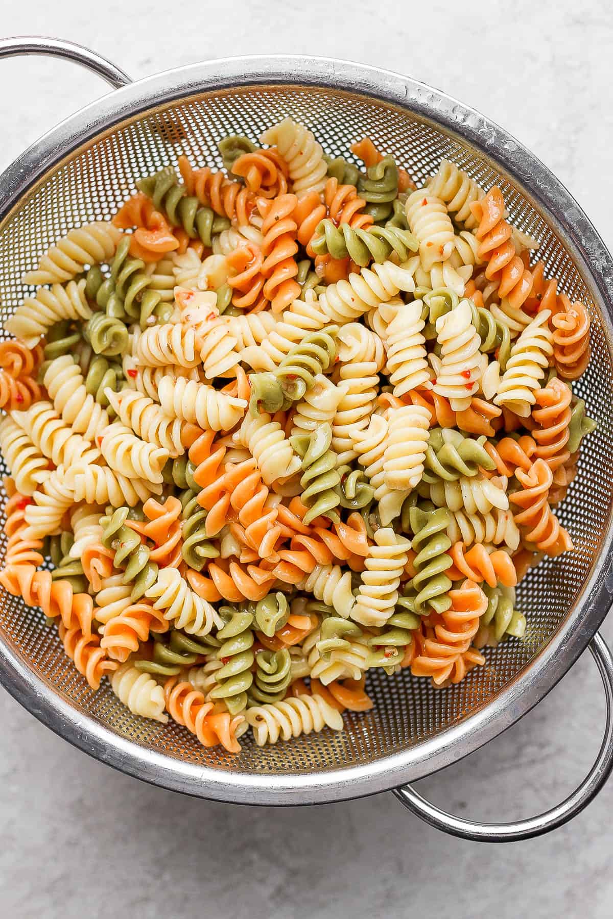 Cooked noodles in a strainer. 