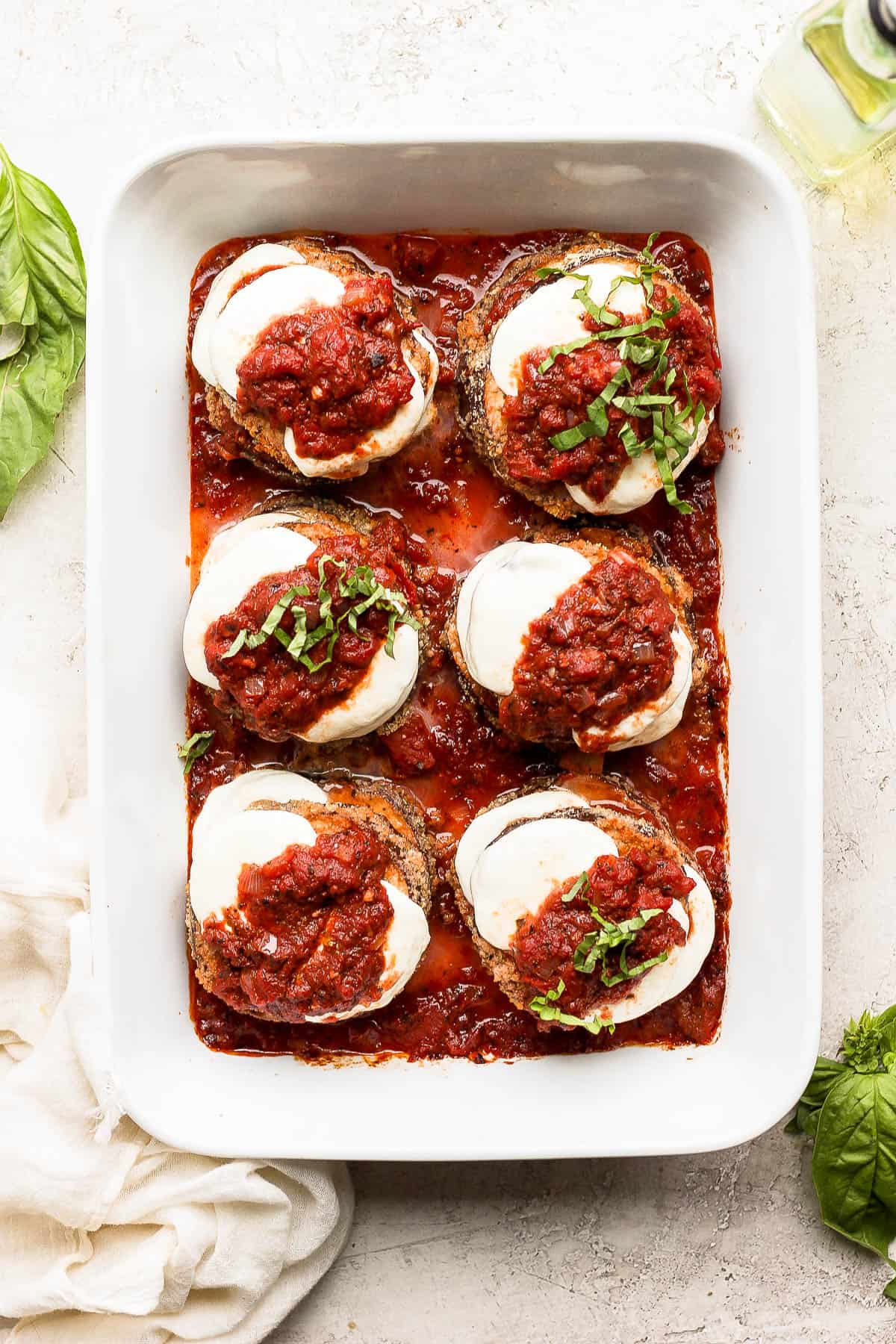 Fully cooked eggplant parmesan in a baking dish.