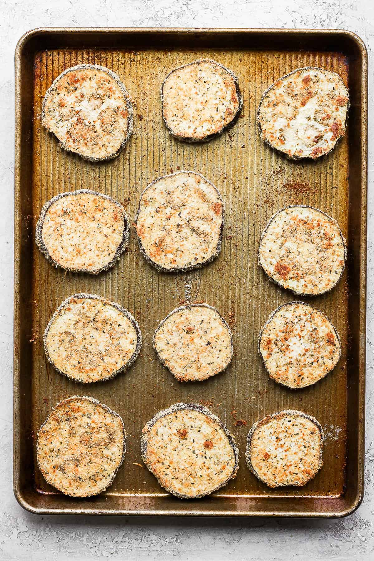 Baked breaded eggplant on a baking sheet.