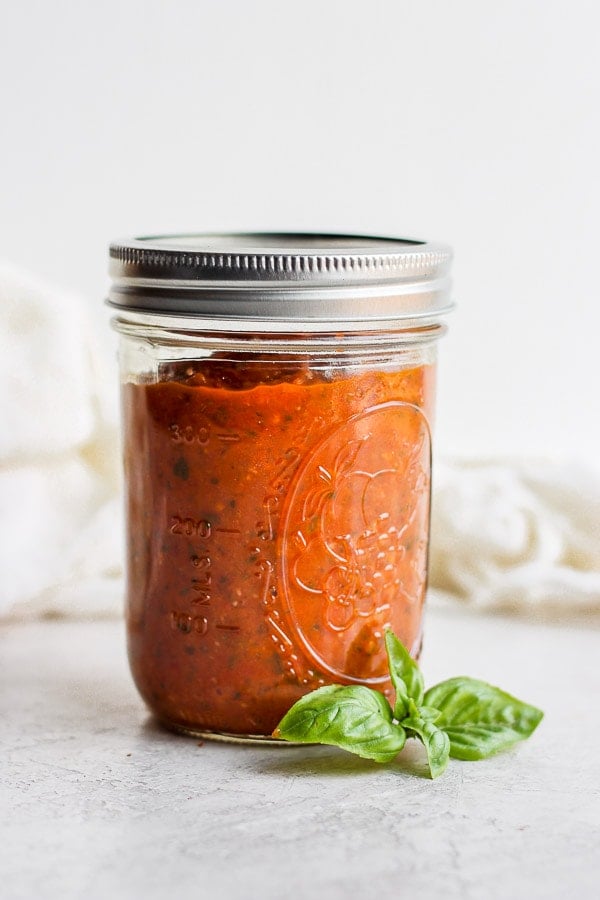 Mason jar of homemade marinara sauce.