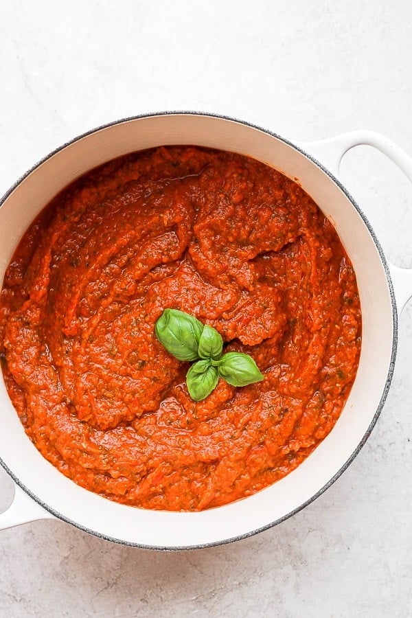 A dutch oven filled with spaghetti sauce. 