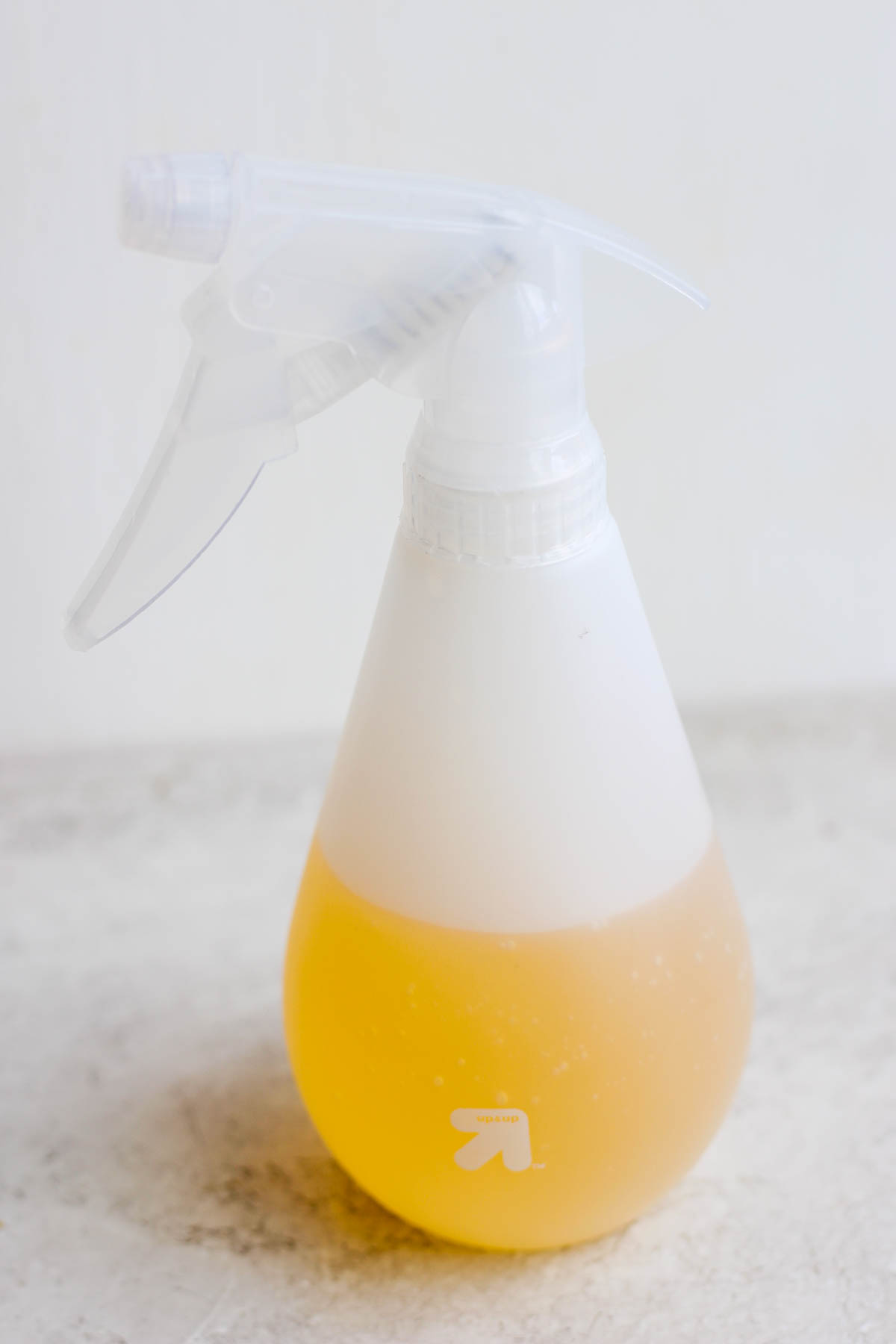 A plastic spray bottle with a mop mixture inside. 