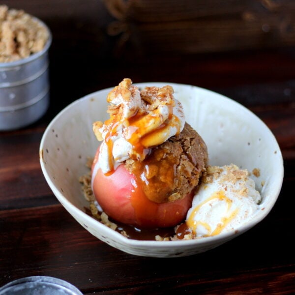 Stuffed Apples + Cardamom Whipped Cream and Vanilla Bean Ice Cream topped with Walnuts and Caramel Sauce. The perfect dessert for fall! Includes instructions on how to make homemade whipped cream! thewoodenskillet.com #foodphotography #foodstyling