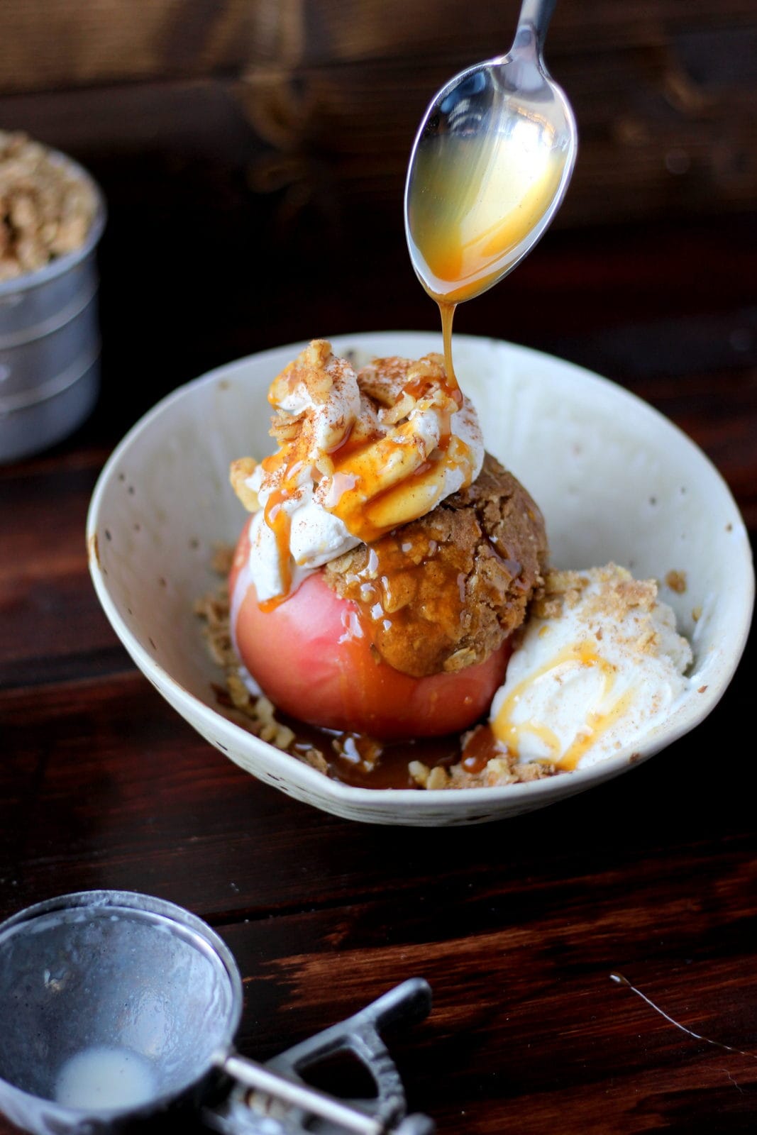 Stuffed Apples + Cardamom Whipped Cream and Vanilla Bean Ice Cream topped with Walnuts and Caramel Sauce. The perfect dessert for fall! Includes instructions on how to make homemade whipped cream! thewoodenskillet.com #foodphotography #foodstyling