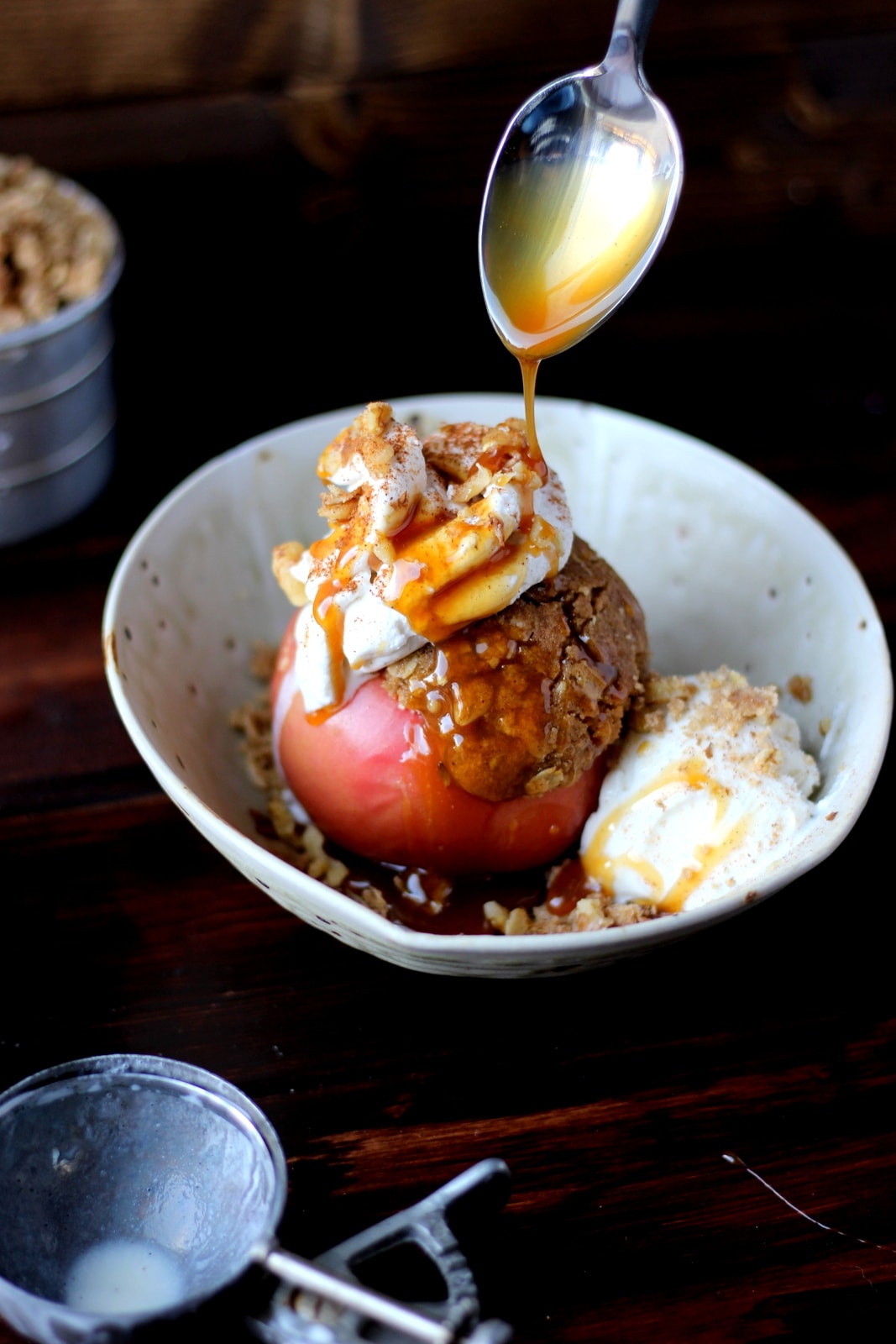 Stuffed Apples + Cardamom Whipped Cream and Vanilla Bean Ice Cream topped with Walnuts and Caramel Sauce. The perfect dessert for fall! thewoodenskillet.com #foodphotography #foodstyling