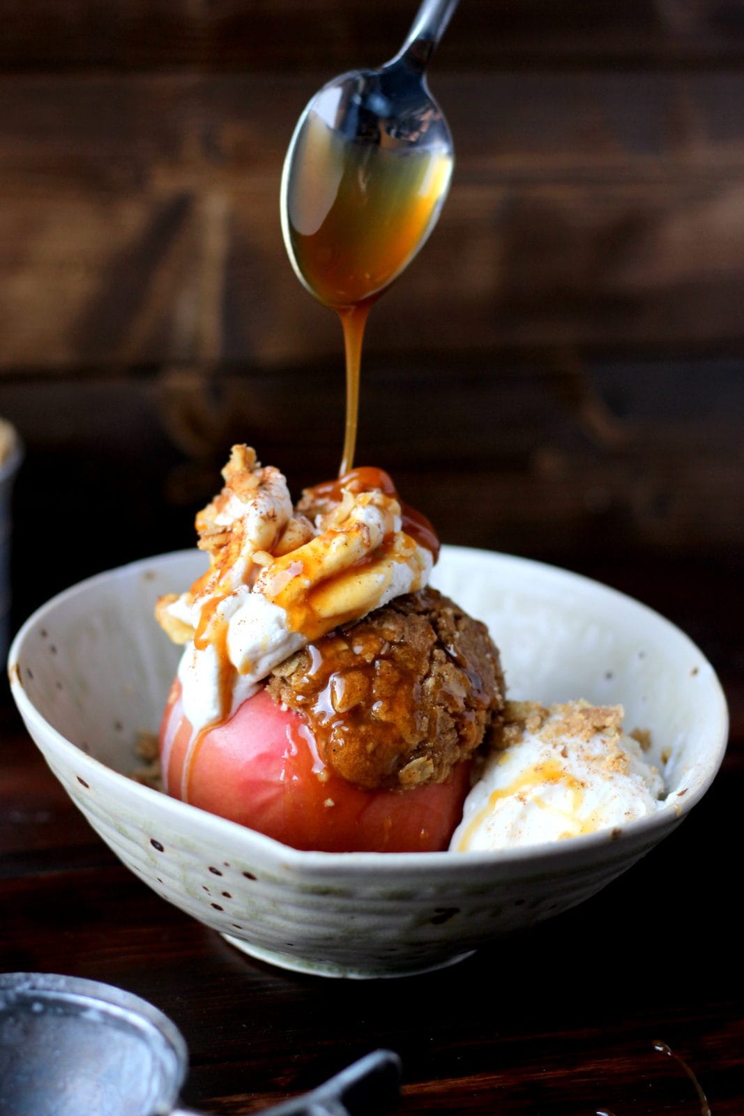 Stuffed Apples + Cardamom Whipped Cream and Vanilla Bean Ice Cream topped with Walnuts and Caramel Sauce. The perfect dessert for fall! Includes instructions on how to make homemade whipped cream! thewoodenskillet.com #foodphotography #foodstyling #apples