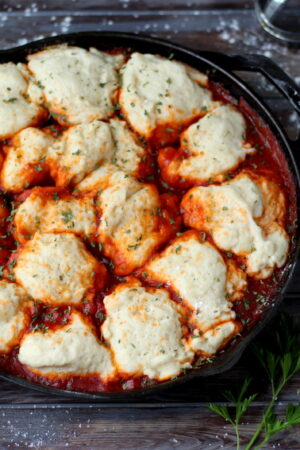 Meatballs and Dumplings - recipe for pillow soft dumplings served with meatballs simmered in tomato sauce. Perfect recipe for a weeknight meal! thewoodenskillet.com #foodphotography #foodstyling
