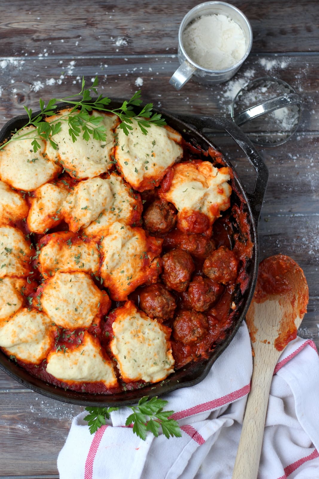 Meatballs and Dumplings - recipe for pillow soft dumplings served with meatballs simmered in tomato sauce. Perfect recipe for a weeknight meal! thewoodenskillet.com #foodphotography #foodstyling