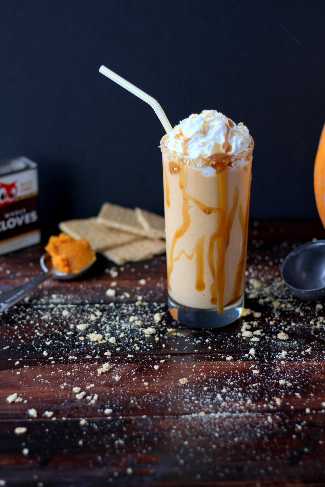 A pumpkin pie malt on a table with crushed graham crackers.