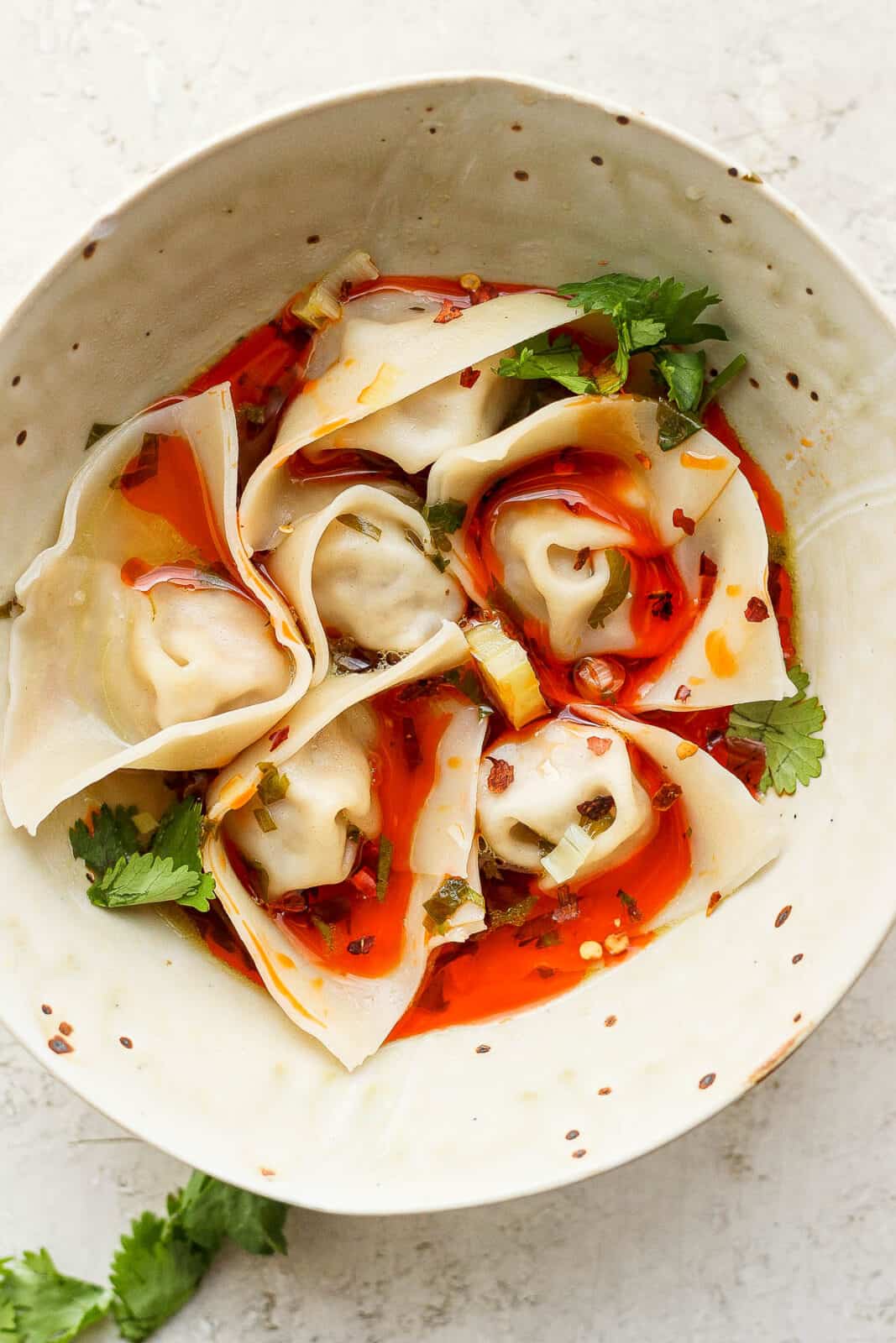 A bowl of spicy pork wontons.