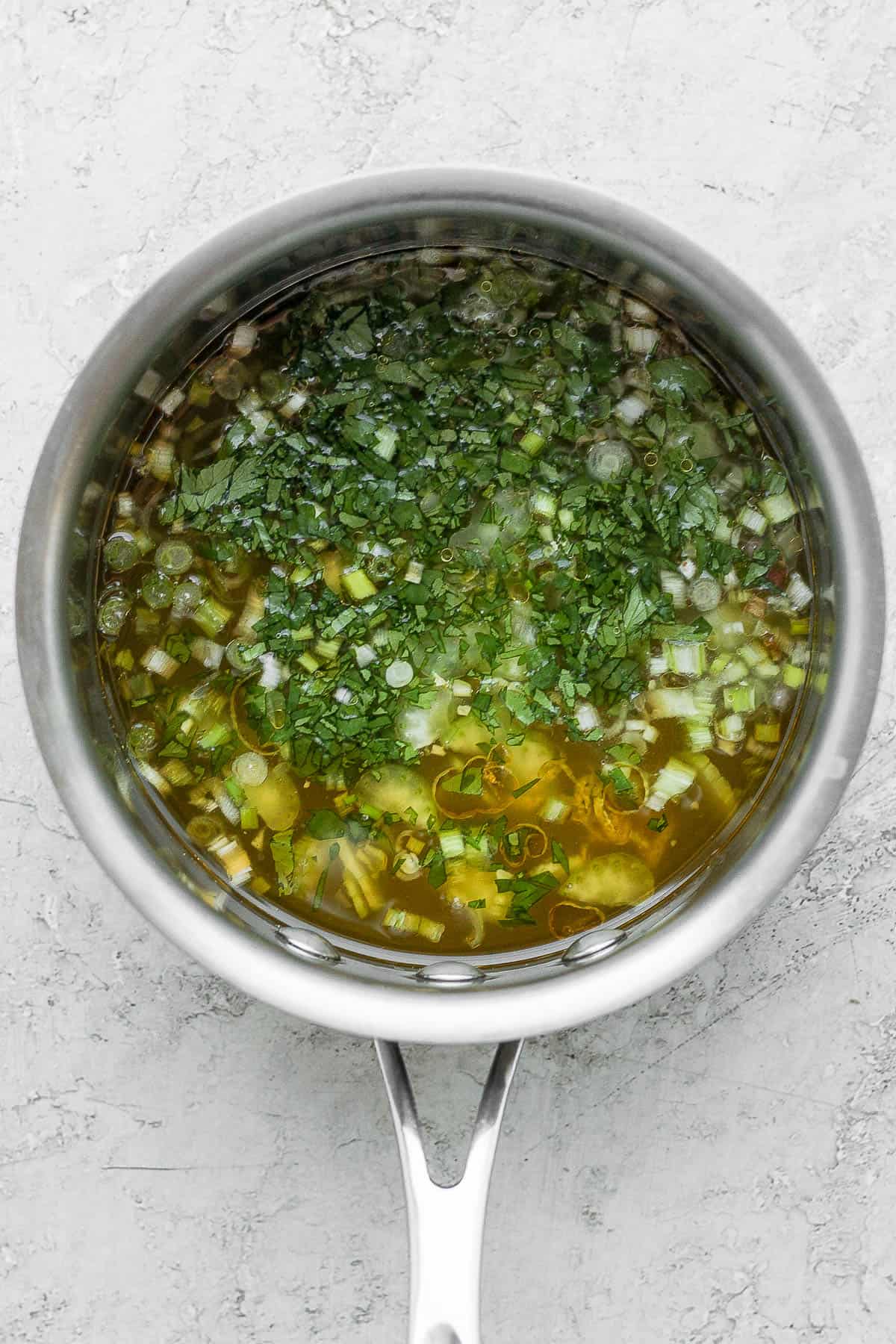 Saucepan filled with the broth that will be poured over the wontons.