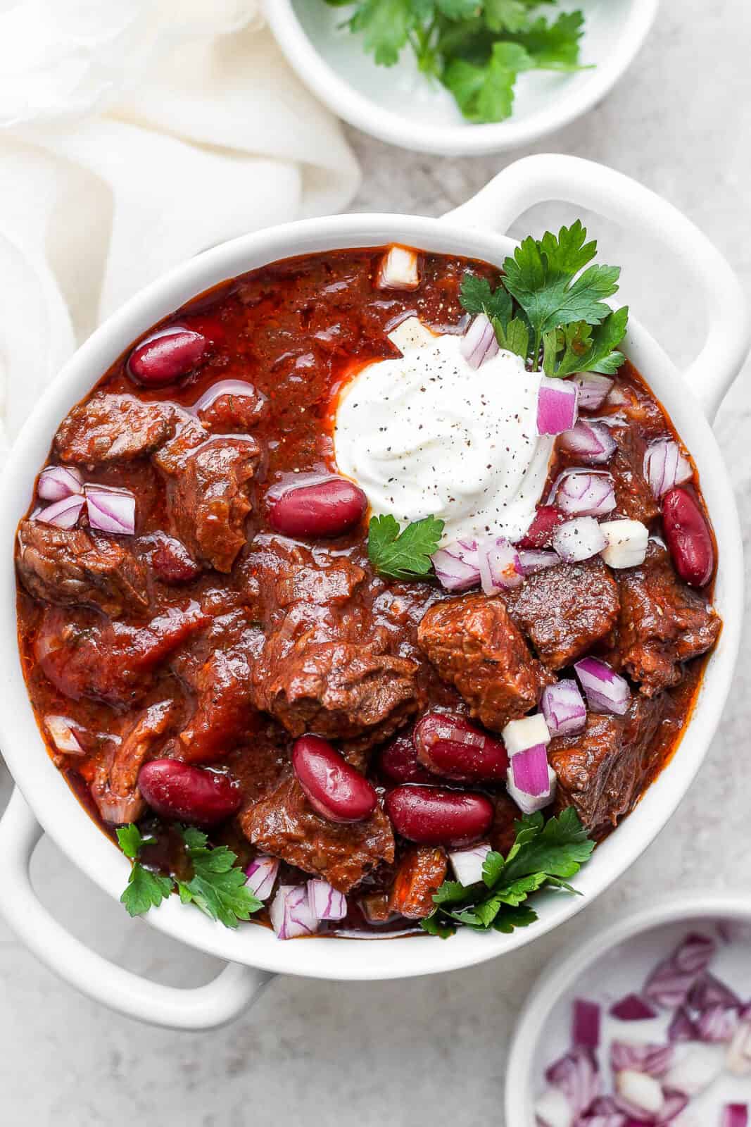 A bowl of Short Rib Chili topped with horseradish sour cream.