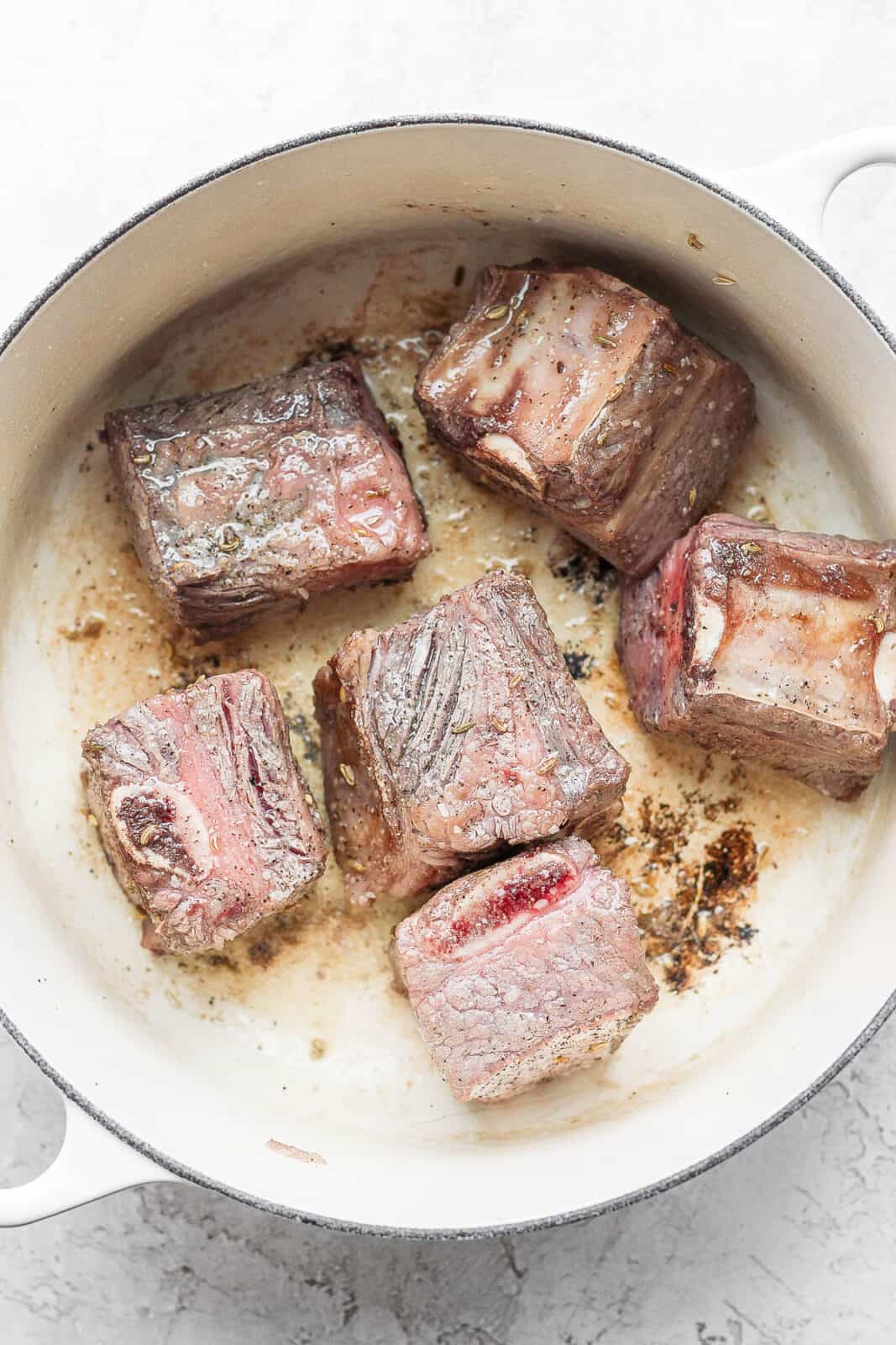 Short ribs being seared in a Dutch Oven.
