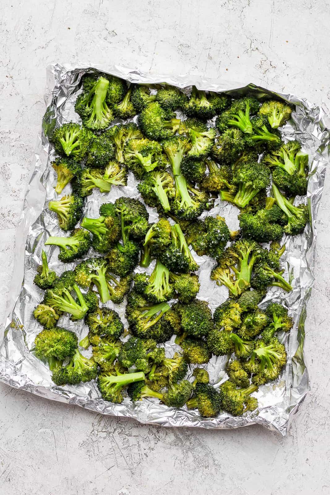 Smoked broccoli in an aluminum foil boat.