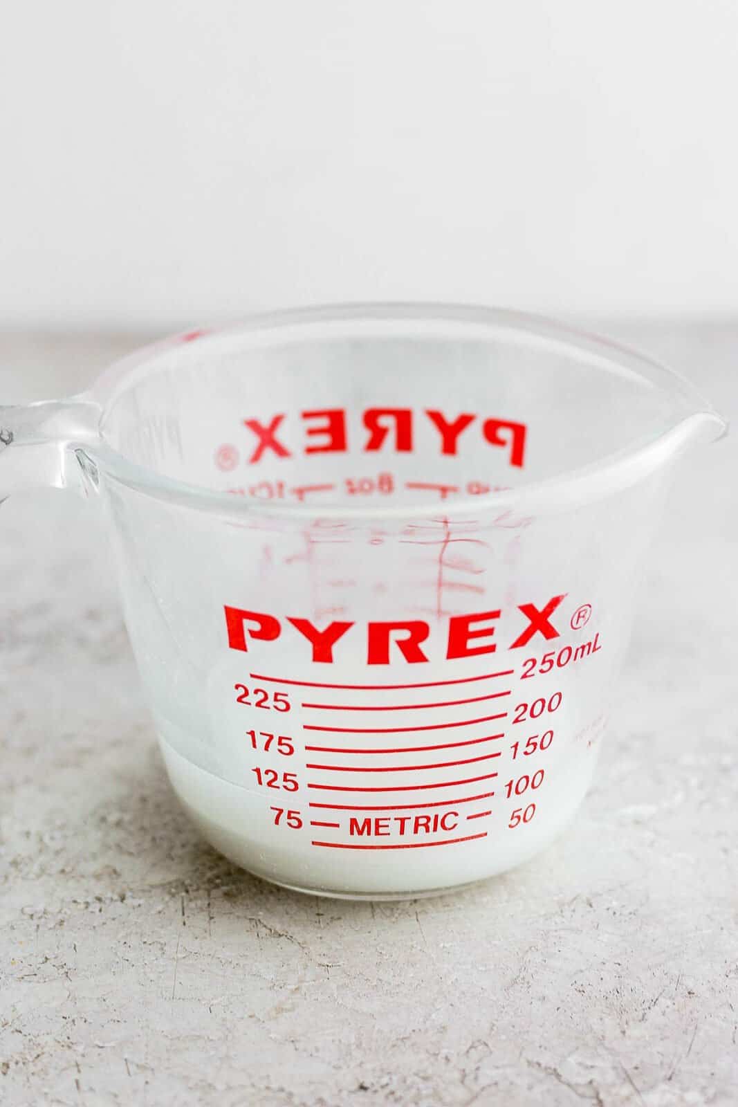 A slurry in a glass measuring cup. 