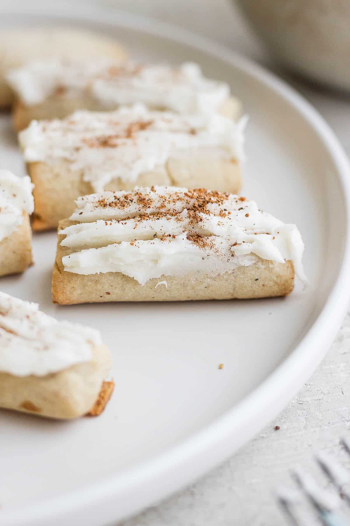 Rum buttered nutmeg logs on a white plate.