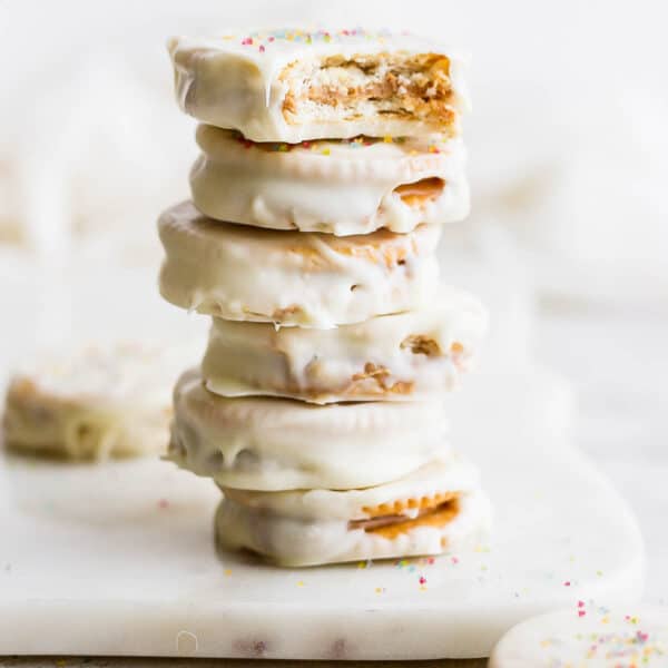 A stack of six Ritz Cookies with sprinkles on top.