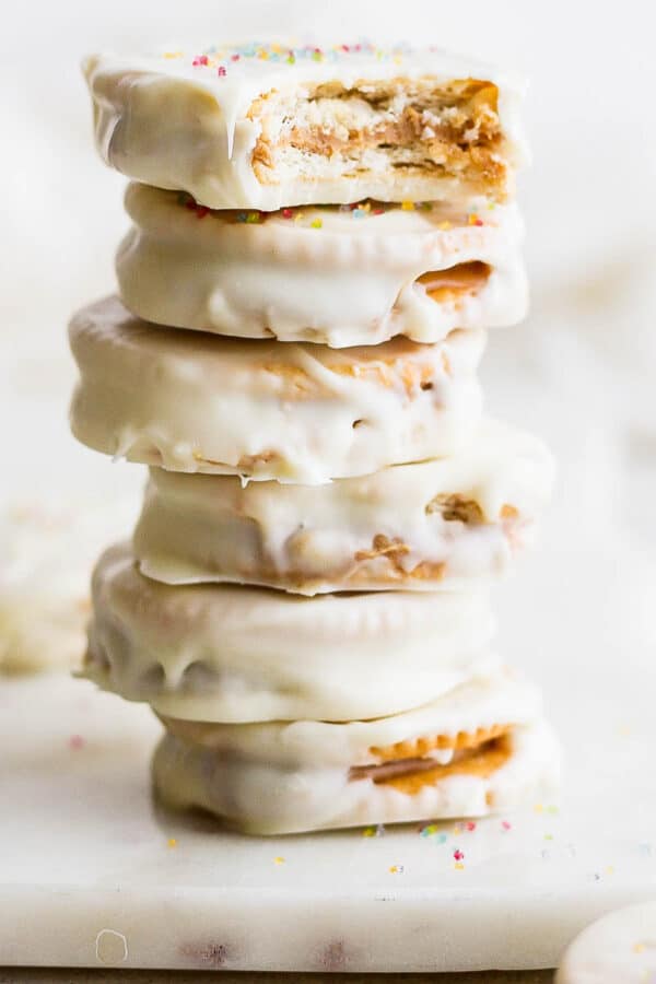 A stack of six Ritz Cookies with sprinkles on top.