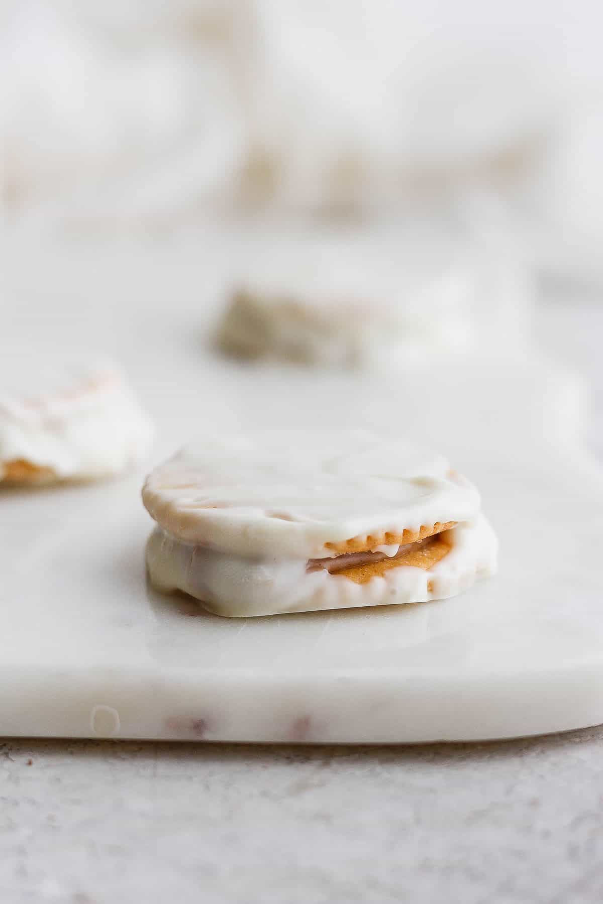 A Ritz Cookie on a white marble board.