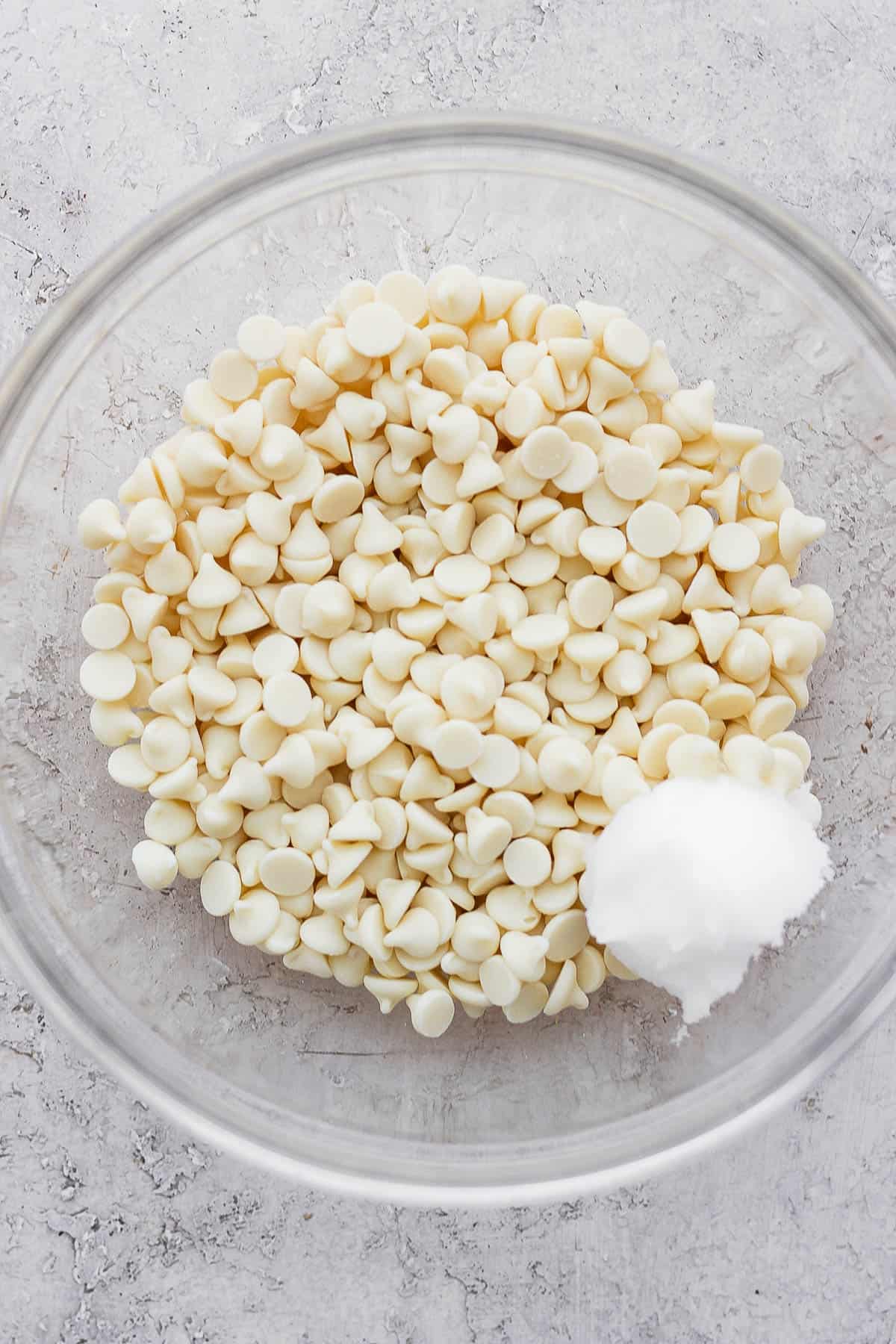 Bowl of white chocolate chips and coconut oil.