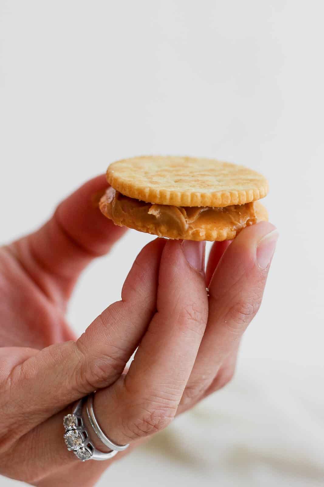 A peanut butter sandwich with ritz crackers. 