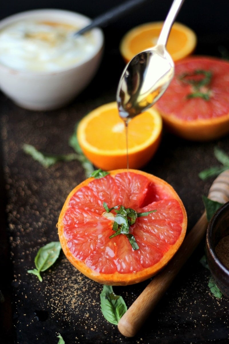 Honey being drizzled on a caramelized grapefruit.