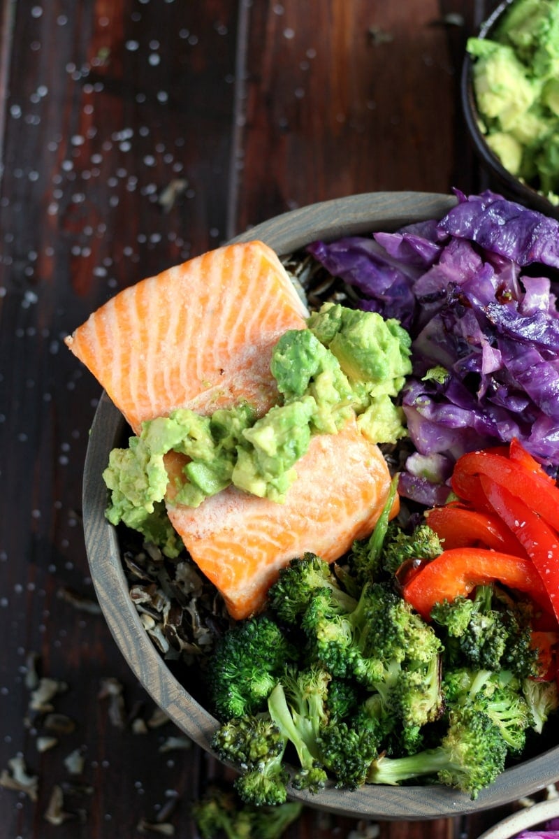 A close-up shot of the mashed avocado added on top of the salmon.