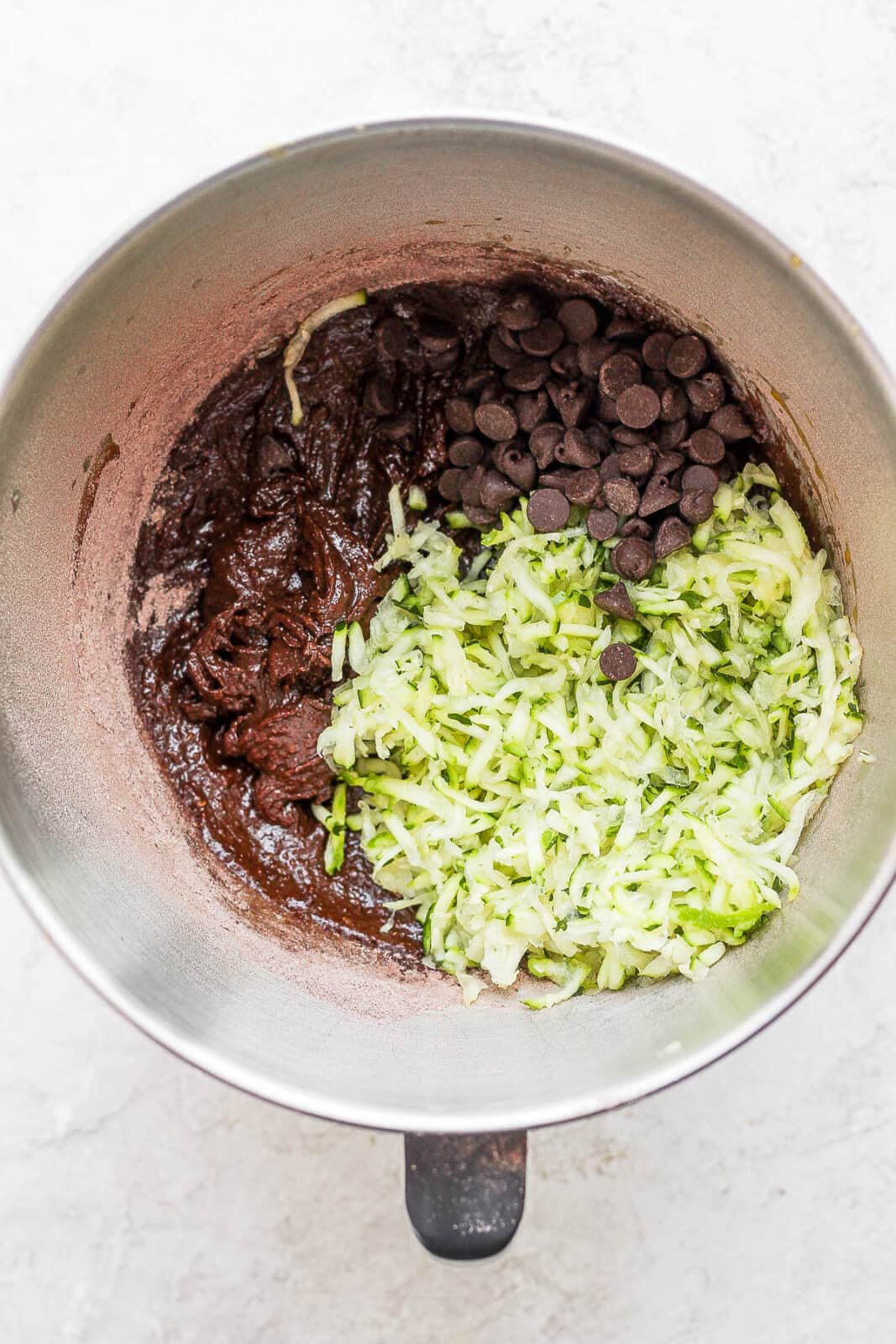 Ingredients for zucchini brownies in a mixing bowl. 