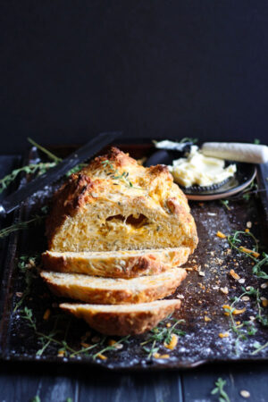 Cheesy Irish Soda Bread + Fresh Thyme and Rosemary. A cheesy twist on the classic Irish tradition - the perfect recipe for St. Patrick's Day! thewoodenskillet.com